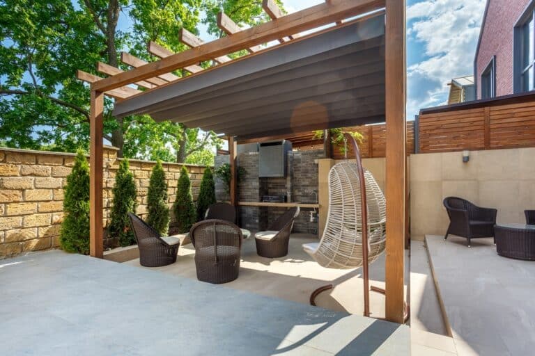 Backyard,Outdoor,Bbq,Zone,With,Pergola,,Fireplace,And,Hanging,Chair.
