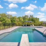 custom swimming pool contractor designing a backyard oasis